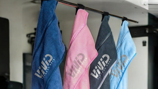VIVID hooded gym towels in blue, pink, grey and light blue hanging up to dry
