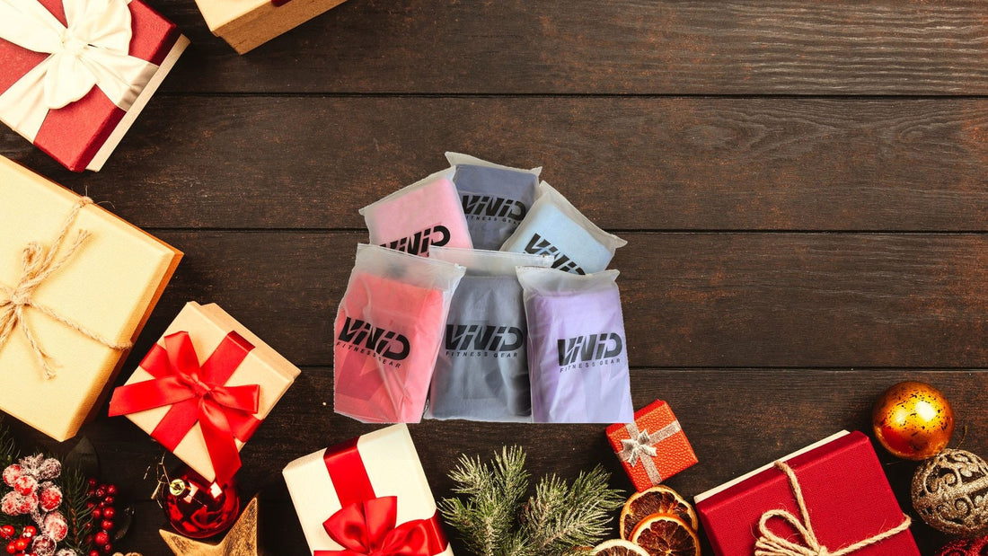 VIVID Fitness Gear towel pouches on a festive wooden flat-lay for Christmas gym gifts (background Photo: Designecologist / Pexels)